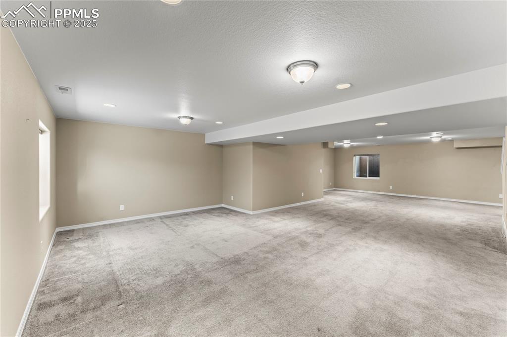 6208 Ashmore Road Colorado Springs, CO 80927 - Photo 32 of 50 Basement with light colored carpet, recessed lighting, and a textured ceiling