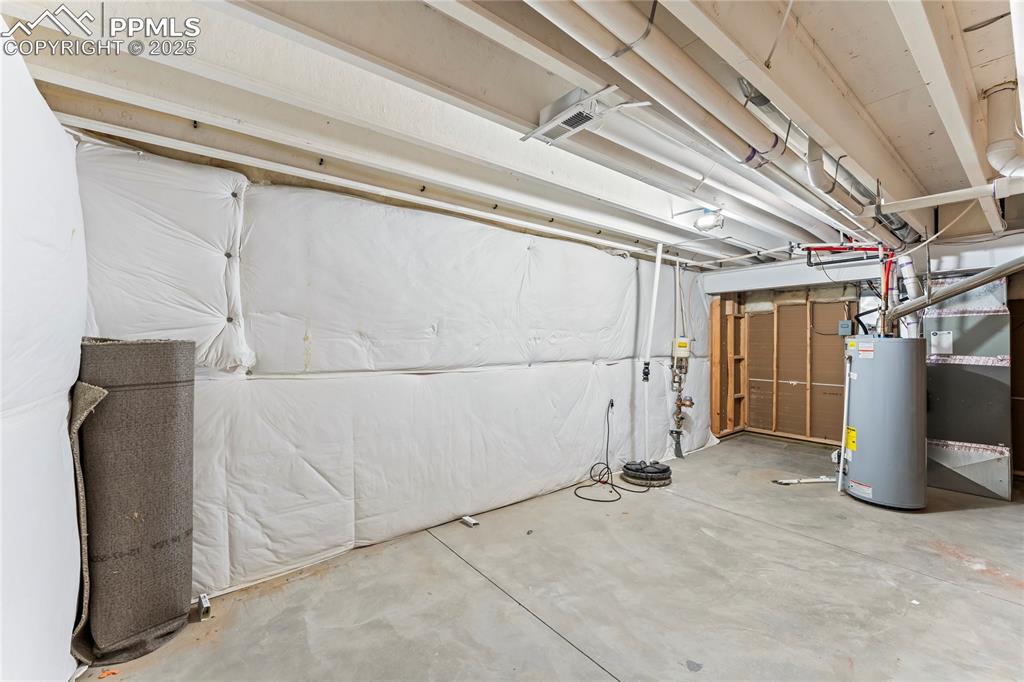 6208 Ashmore Road Colorado Springs, CO 80927 - Photo 41 of 50 Unfinished below grade area with water heater and heating unit