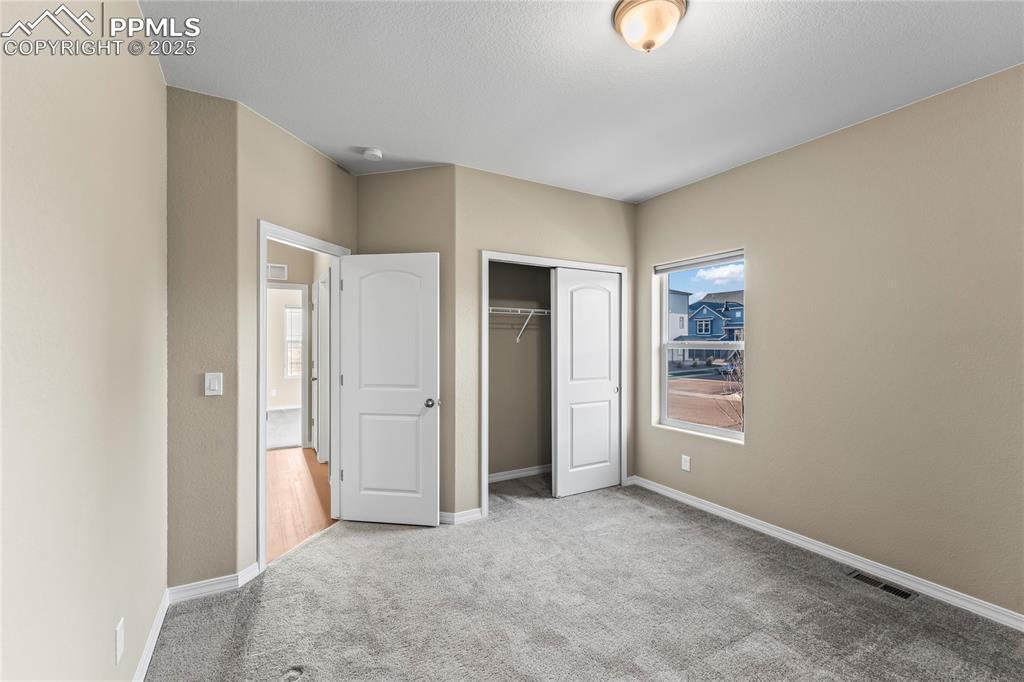 6208 Ashmore Road Colorado Springs, CO 80927 - Photo 7 of 50 Unfurnished bedroom with carpet flooring and a closet