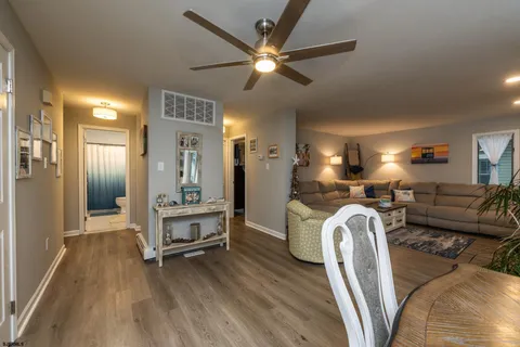 a living room with furniture a fireplace a flat screen tv and potted plant