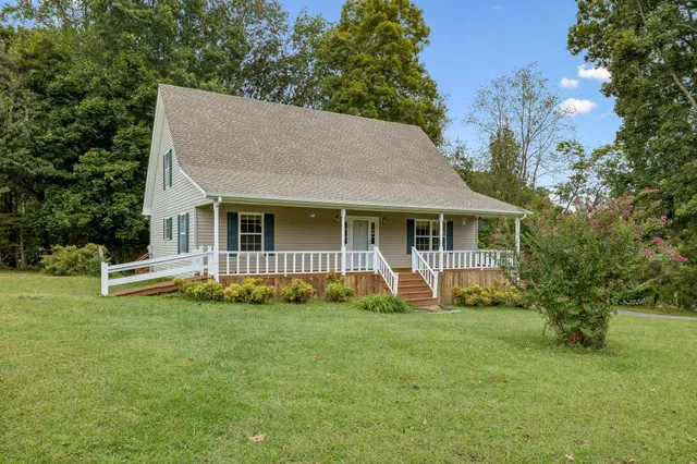 a view of a house with a yard and sitting area