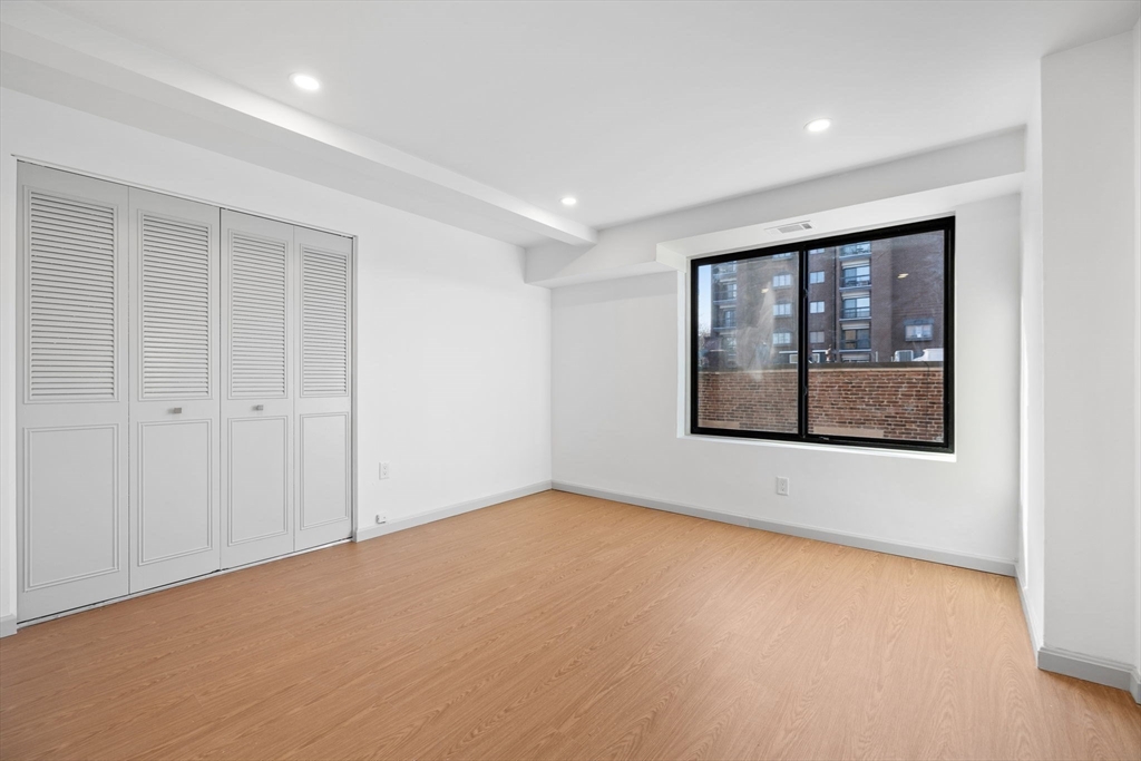 1243 Beacon Street, Unit 5A Brookline, MA 02446 - Photo 15 of 21 an empty room with windows