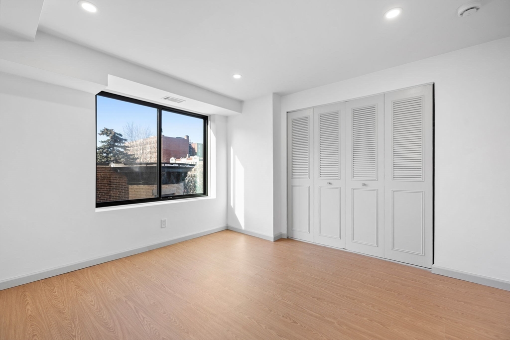 1243 Beacon Street, Unit 5A Brookline, MA 02446 - Photo 16 of 21 an empty room with a window