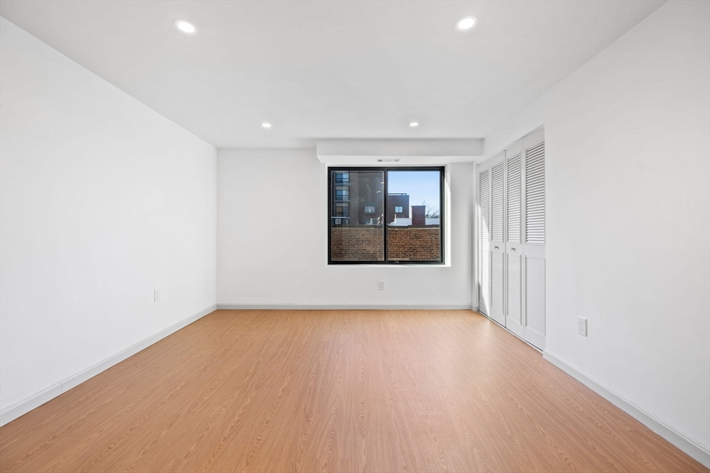 1243 Beacon Street, Unit 5A Brookline, MA 02446 - Photo 18 of 21 a view of hallway with wooden floor