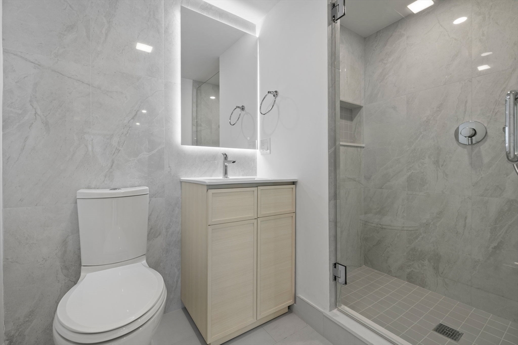 1243 Beacon Street, Unit 5A Brookline, MA 02446 - Photo 3 of 21 a white toilet sitting next to a bathroom sink