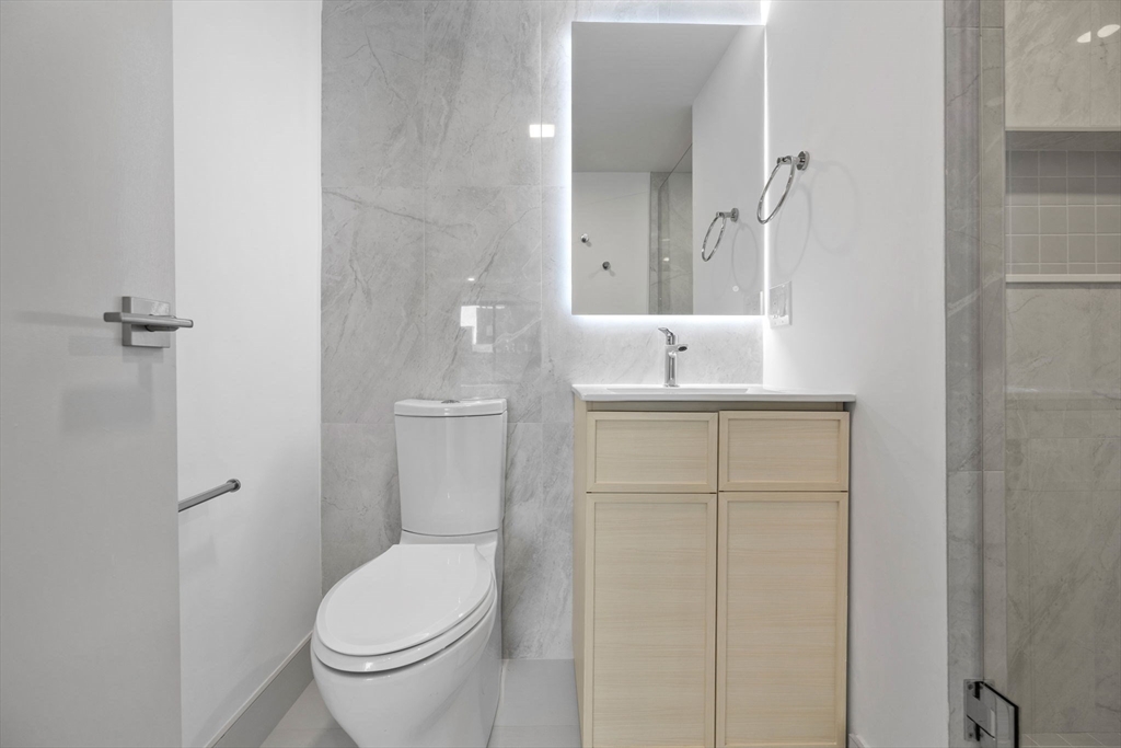 1243 Beacon Street, Unit 5A Brookline, MA 02446 - Photo 9 of 21 a bathroom with a sink a toilet and shower