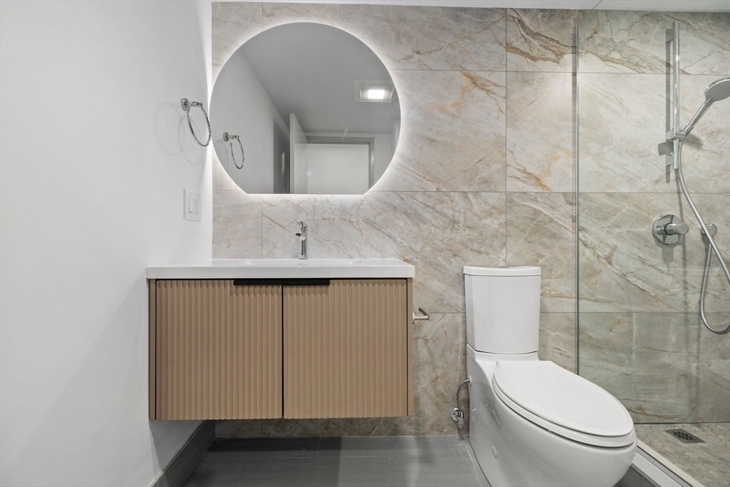 1243 Beacon Street, Unit 5A Brookline, MA 02446 - Photo 10 of 21 a bathroom with a toilet sink and mirror