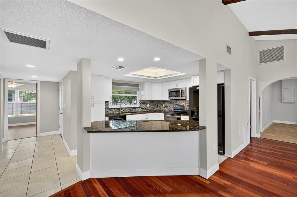 302 Leafwood Road Tarpon Springs, FL 34689 - Photo 12 of 55 a kitchen with stainless steel appliances granite countertop a refrigerator and a sink