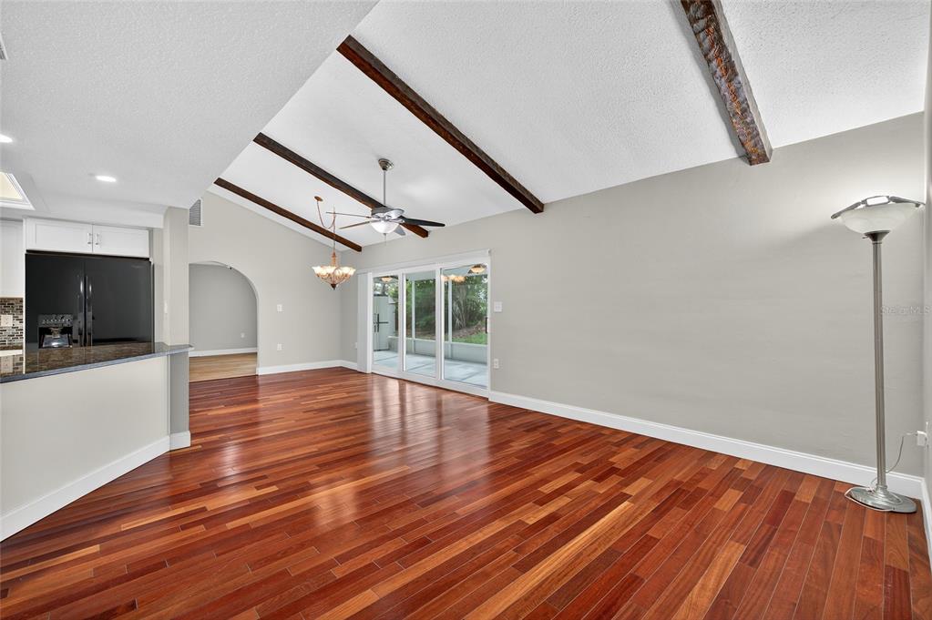 302 Leafwood Road Tarpon Springs, FL 34689 - Photo 13 of 55 a view of empty room with wooden floor and fan