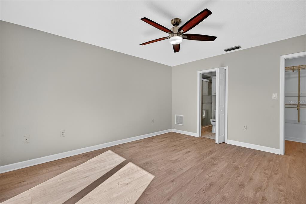 302 Leafwood Road Tarpon Springs, FL 34689 - Photo 19 of 55 an empty room with a window and a ceiling fan