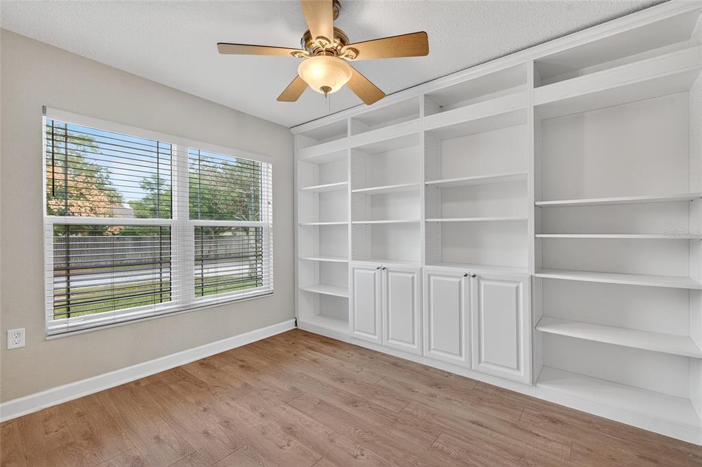 302 Leafwood Road Tarpon Springs, FL 34689 - Photo 26 of 55 a view of an empty room with a window and wooden floor