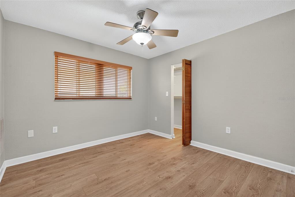 302 Leafwood Road Tarpon Springs, FL 34689 - Photo 29 of 55 wooden floor in an empty room with a window