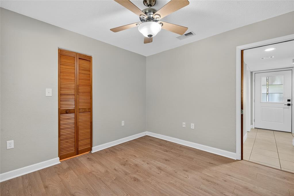 302 Leafwood Road Tarpon Springs, FL 34689 - Photo 30 of 55 wooden floor in an empty room with a window