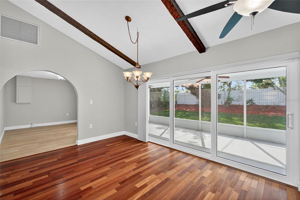 302 Leafwood Road Tarpon Springs, FL 34689 - Photo 3 of 55 a view of empty room with wooden floor and fan