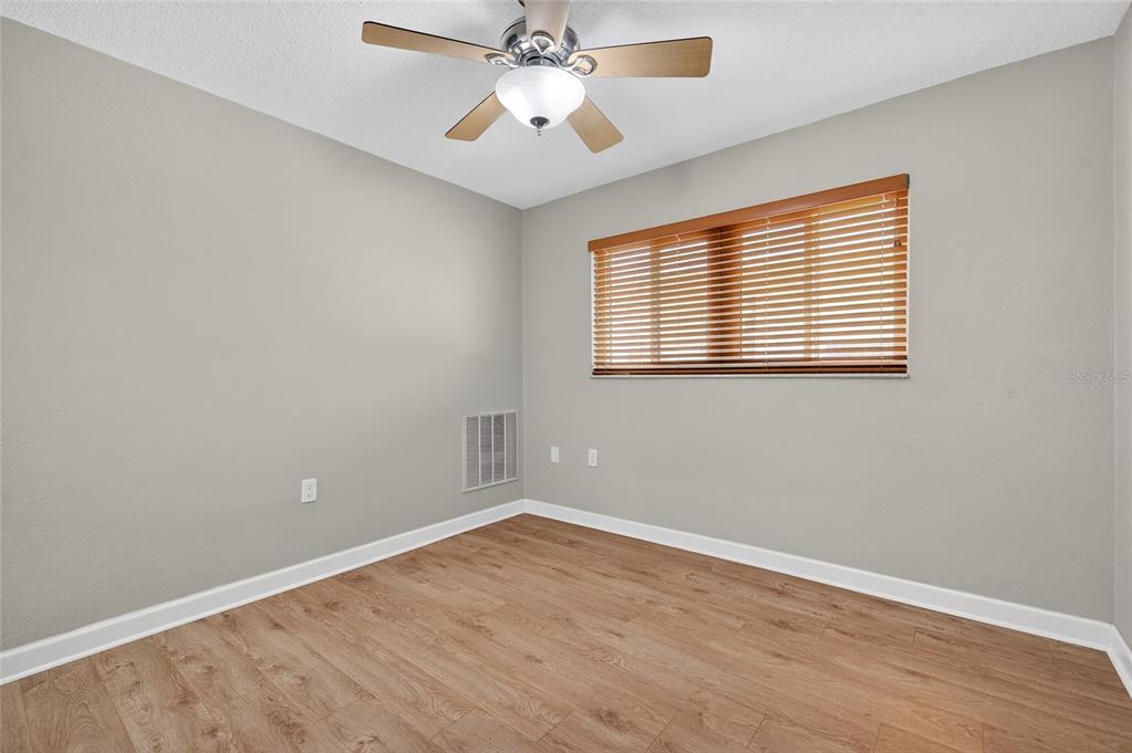 302 Leafwood Road Tarpon Springs, FL 34689 - Photo 31 of 55 a view of an empty room with wooden floor and a window