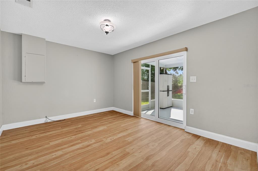 302 Leafwood Road Tarpon Springs, FL 34689 - Photo 32 of 55 a view of an empty room with wooden floor and a window