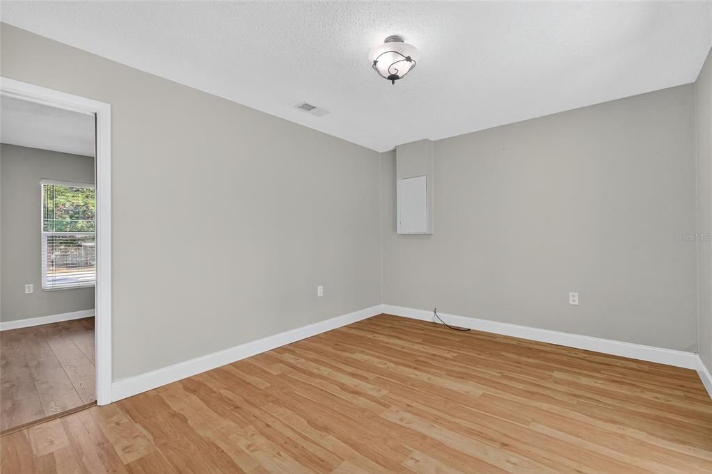 302 Leafwood Road Tarpon Springs, FL 34689 - Photo 33 of 55 wooden floor in an empty room with a window