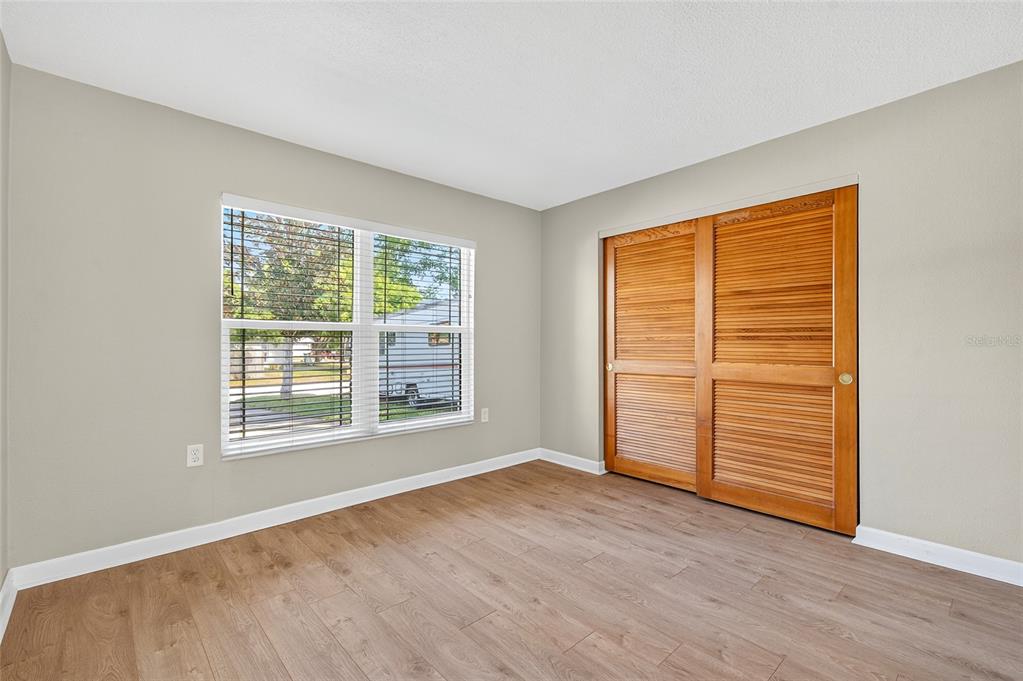 302 Leafwood Road Tarpon Springs, FL 34689 - Photo 35 of 55 a view of empty room with wooden floor and fan