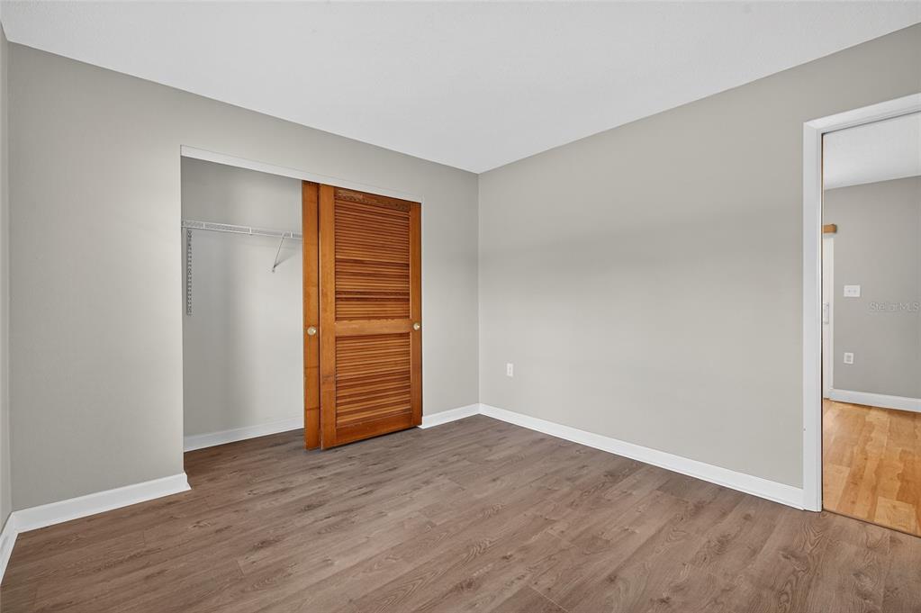 302 Leafwood Road Tarpon Springs, FL 34689 - Photo 36 of 55 a view of an empty room with wooden floor