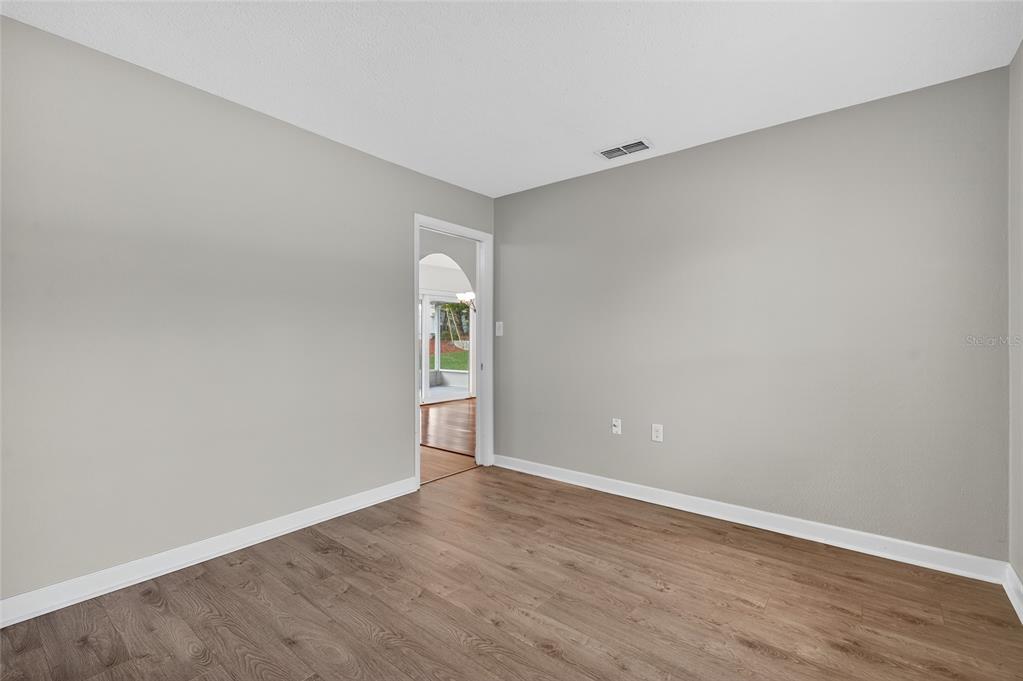 302 Leafwood Road Tarpon Springs, FL 34689 - Photo 37 of 55 a view of an empty room with wooden floor and a window