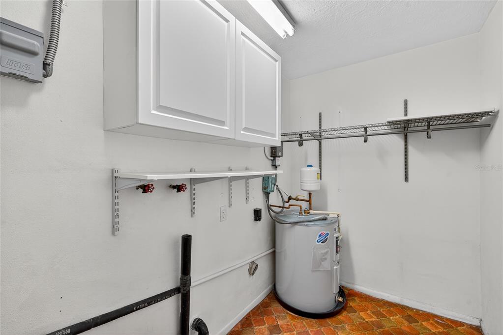 302 Leafwood Road Tarpon Springs, FL 34689 - Photo 39 of 55 a view of storage and utility room with racks on the wall