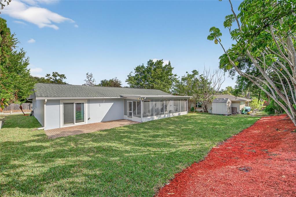 302 Leafwood Road Tarpon Springs, FL 34689 - Photo 46 of 55 a front view of a house with a yard and trees