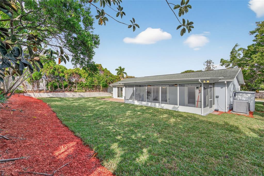 302 Leafwood Road Tarpon Springs, FL 34689 - Photo 47 of 55 a view of a house with a yard