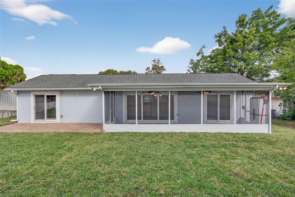 302 Leafwood Road Tarpon Springs, FL 34689 - Photo 49 of 55 a front view of a house with a garden and yard