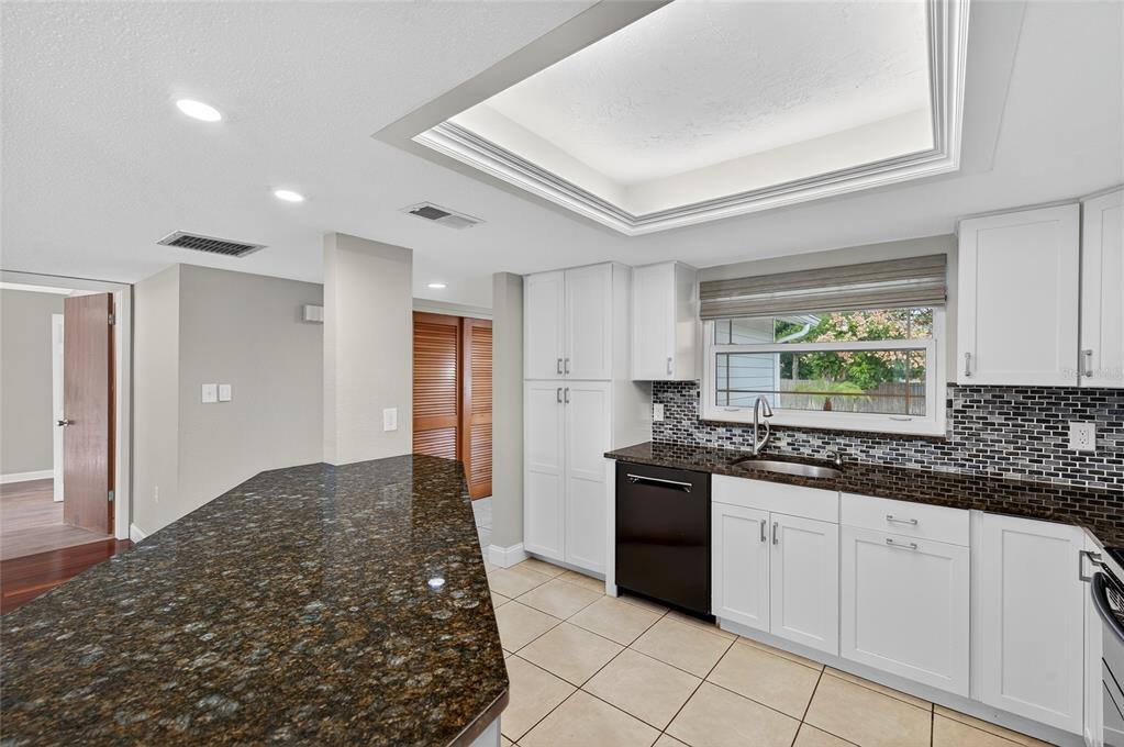 302 Leafwood Road Tarpon Springs, FL 34689 - Photo 9 of 55 a kitchen with stainless steel appliances granite countertop a stove a sink and a refrigerator