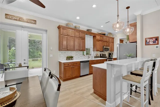 a large kitchen with a table and chairs