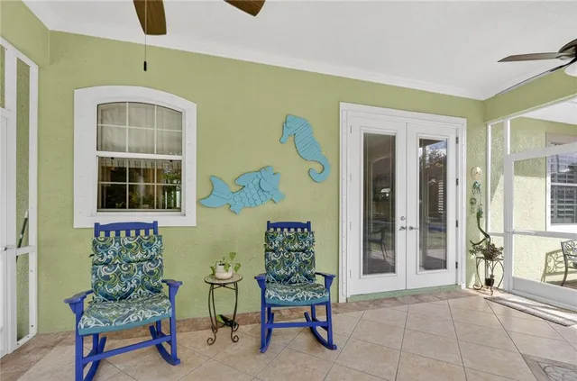 a living room with furniture kitchen view and a chandelier