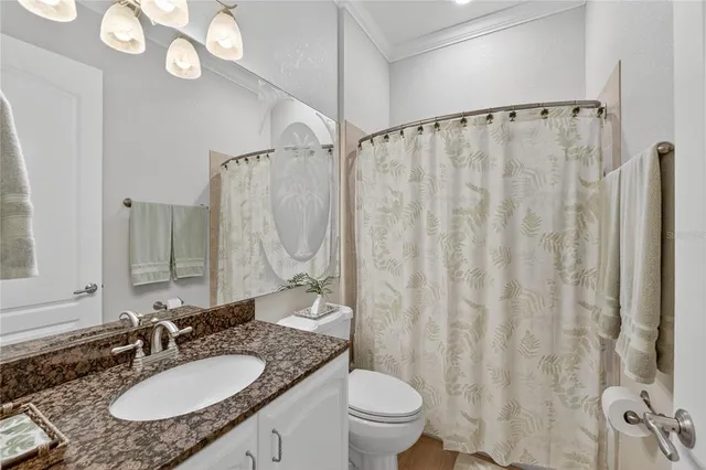 a view of a patio with table and chairs potted plants and a large tree