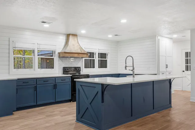 a kitchen with stainless steel appliances granite countertop a stove and a sink