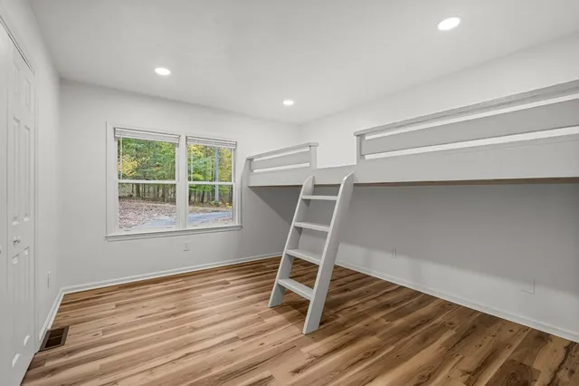 an aerial view of residential house with outdoor space and trees all around