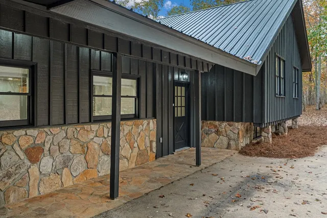 a kitchen with stainless steel appliances granite countertop a large counter top a sink and a large window