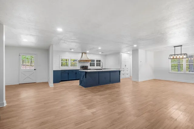 a kitchen with a sink stove and cabinets