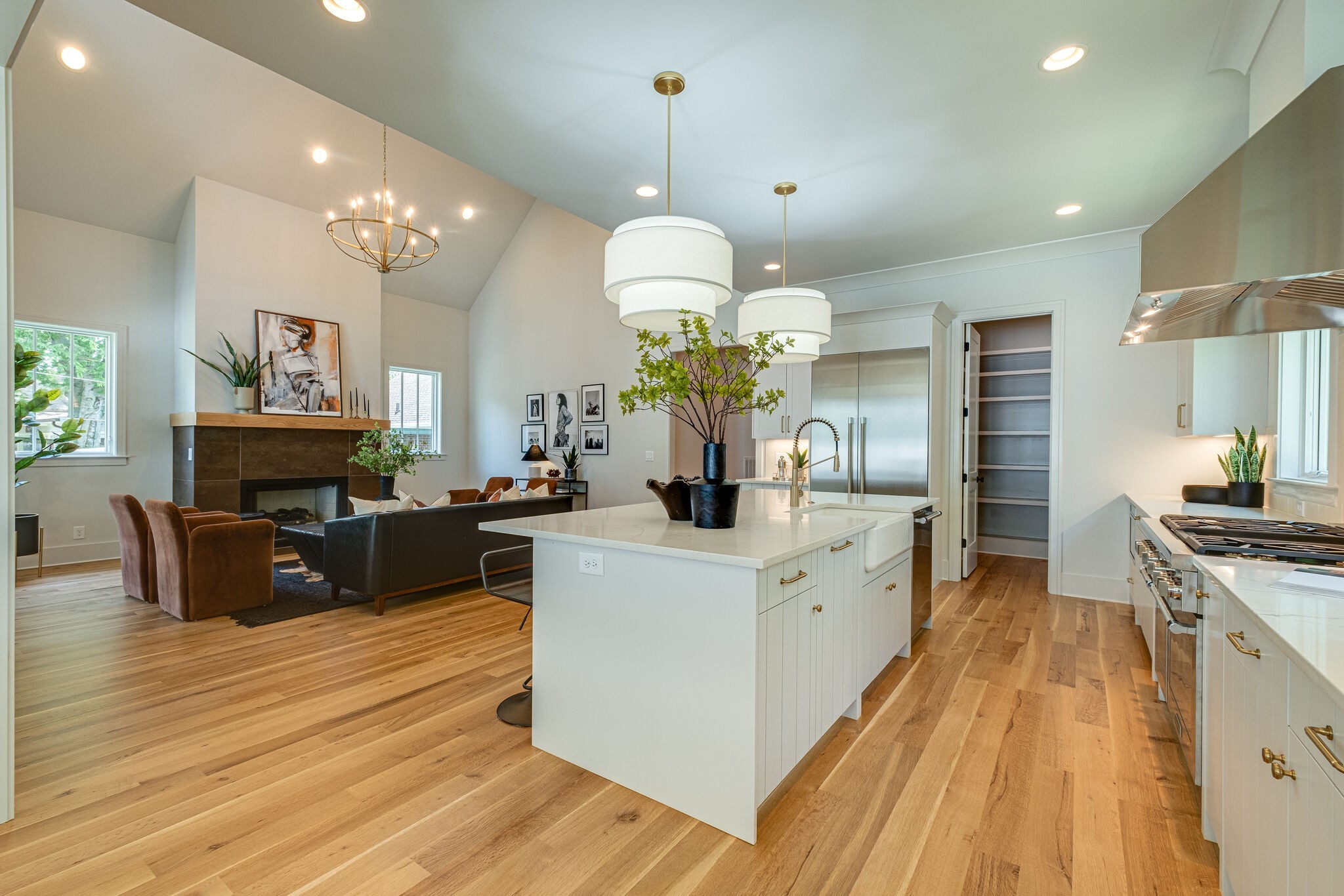 4012 Murphy Road Nashville, TN 37209 - Photo 14 of 63 a large kitchen with stainless steel appliances granite countertop a stove oven a refrigerator a kitchen island with couches chairs and a fireplace