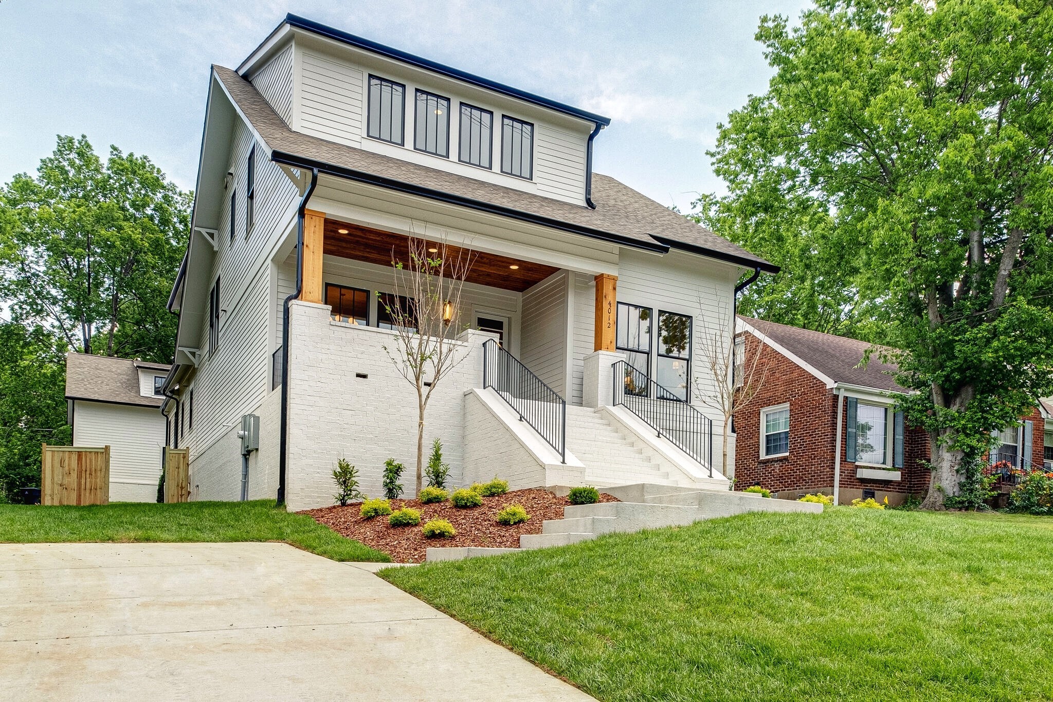4012 Murphy Road Nashville, TN 37209 - Photo 4 of 63 a front view of a house with a yard and garage