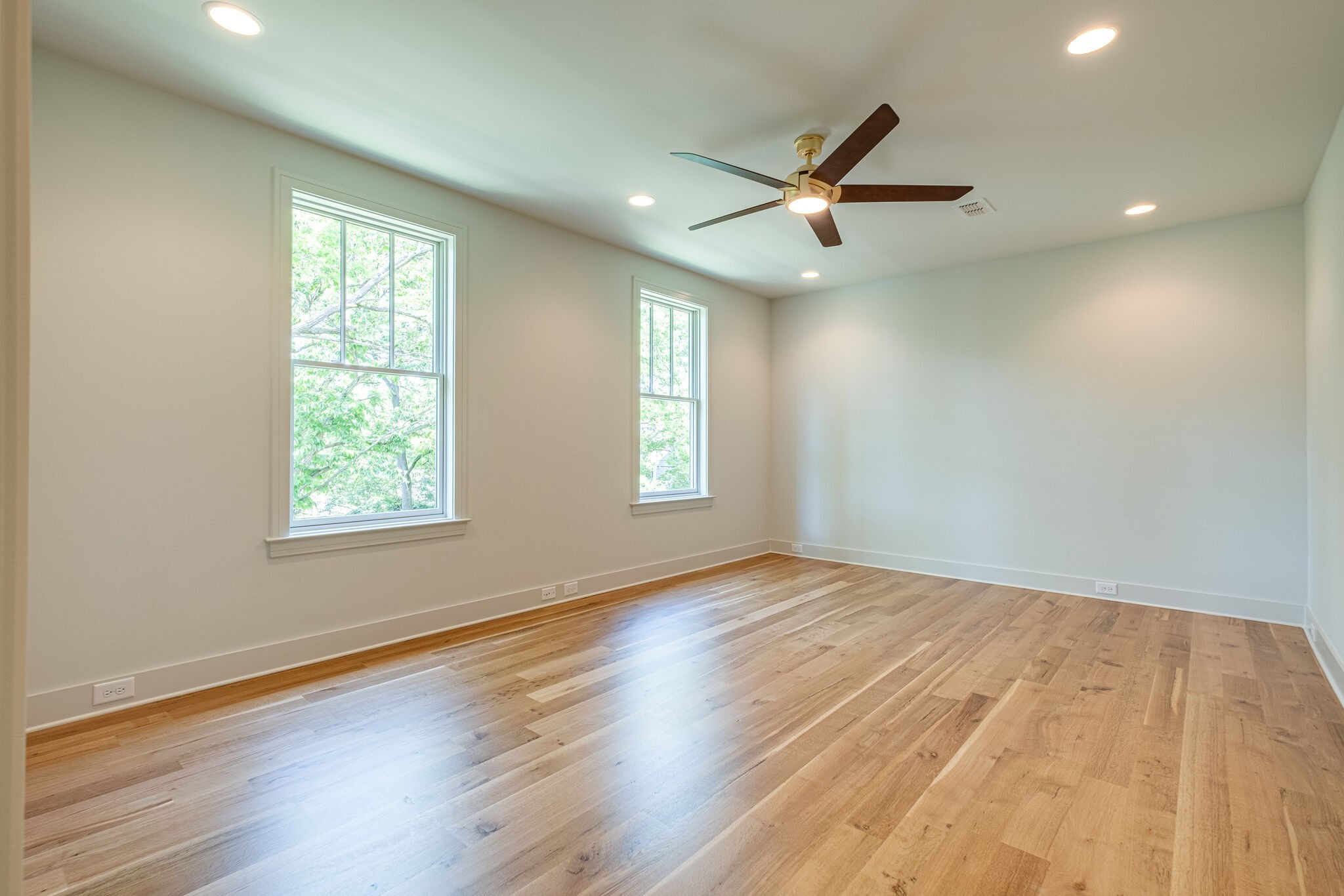 4012 Murphy Road Nashville, TN 37209 - Photo 43 of 63 an empty room with wooden floor ceiling fan and windows