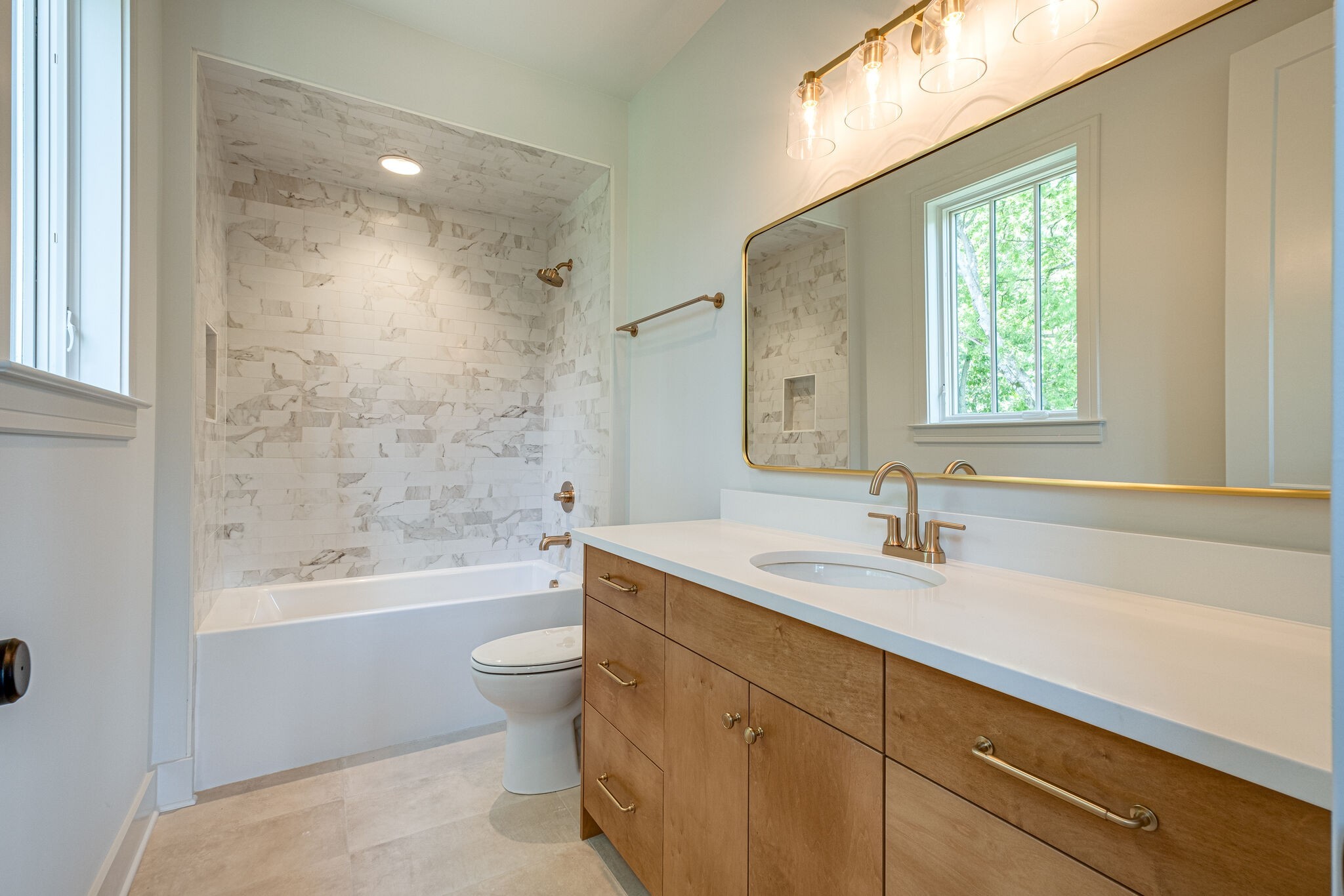 4012 Murphy Road Nashville, TN 37209 - Photo 53 of 63 a bathroom with a bathtub shower sink vanity mirror and toilet