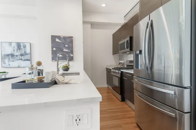 a kitchen with stainless steel appliances a refrigerator and a stove