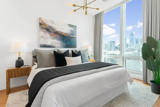 a bedroom with a bed and a painting on the wall