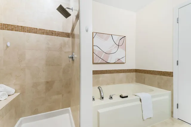 a bathroom with a bathtub and shower