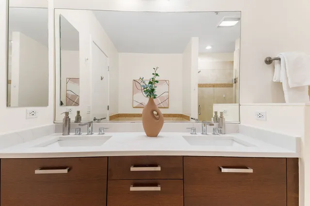 a bathroom with a sink double vanity and a mirror
