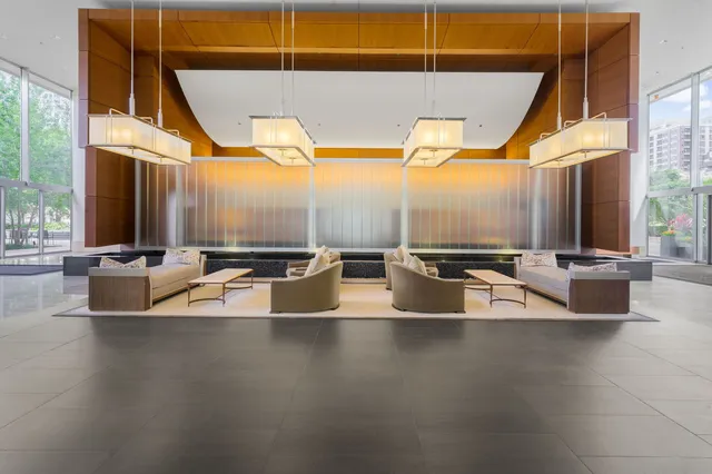 a view of a living room with a sink and large windows