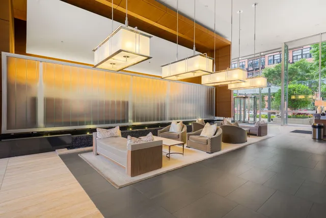 a living room with patio furniture and a floor to ceiling window