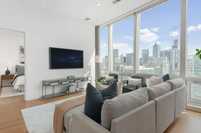 a living room with furniture wooden floor and a flat screen tv