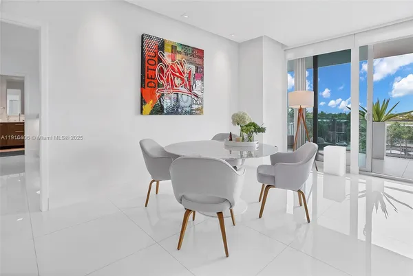 a dining room with furniture and a potted plant