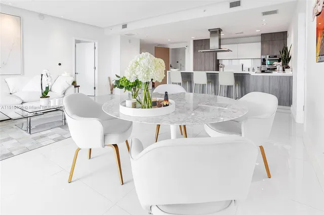 a dining room with furniture and a chandelier