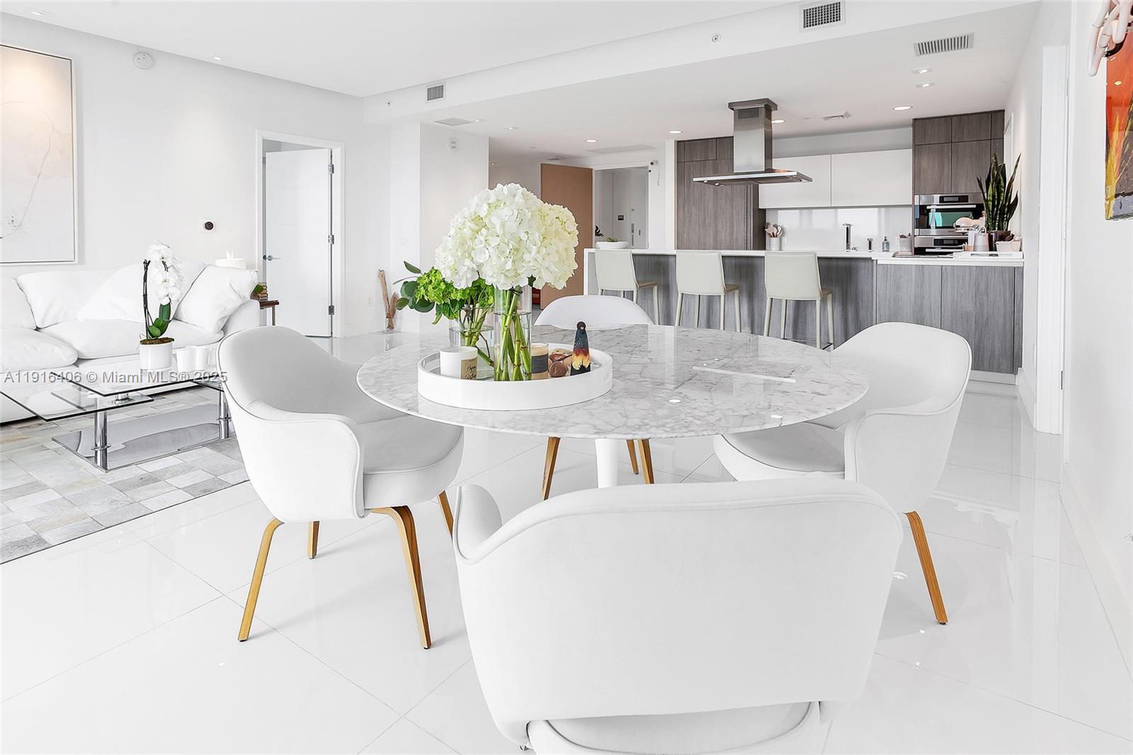 350 Ocean Drive, Unit 405N Key Biscayne, FL 33149 - Photo 14 of 34 a dining room with furniture and a chandelier